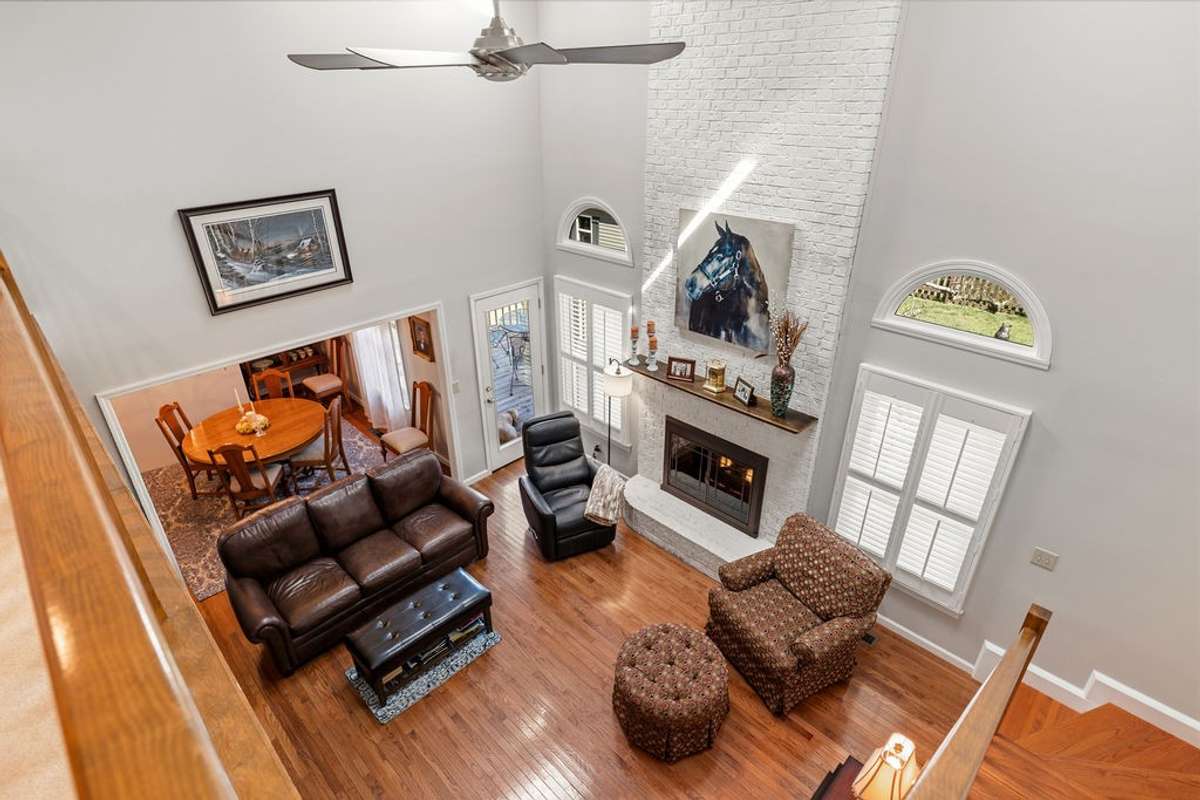 View of Great Room and fireplace from the upstairs balcony.