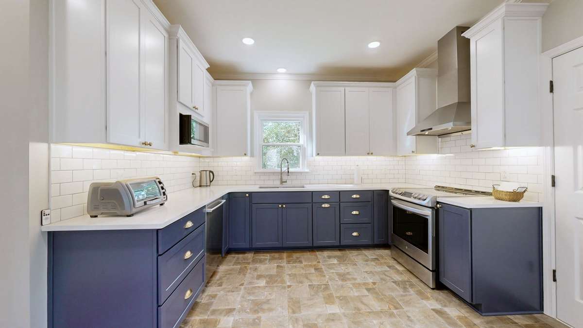 Beautifully updated kitchen has all new cabinets, quartz countertops, tile backsplash and appliances!