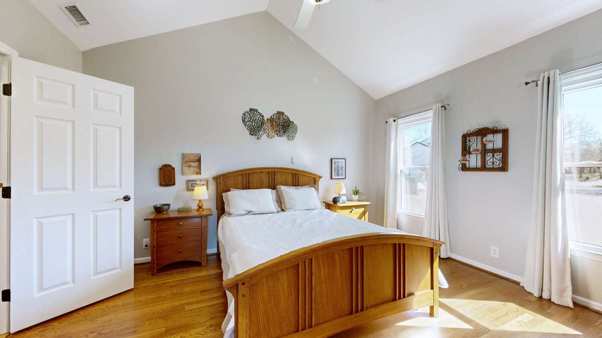 Wonderful vaulted ceilings in the primary bedroom. Notice that the hardwood flooring extends to the upstairs and has also been refinished!