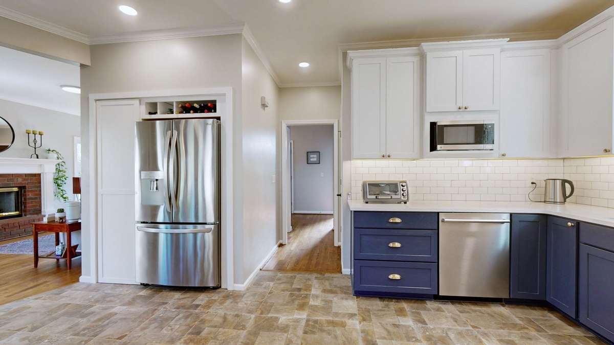 Refrigerator conveys with the property! Extra storage closet beside the refrigerator as well as a pantry located in the small hallway