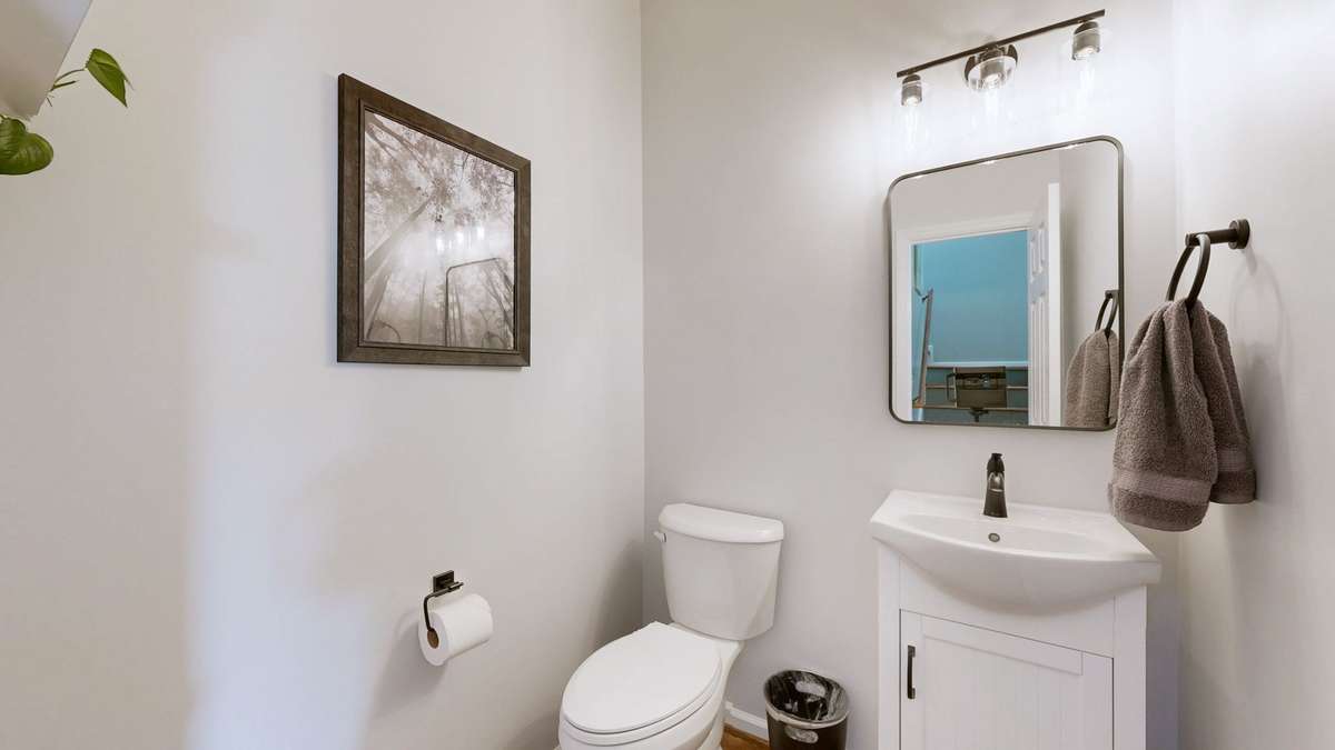 This half bath has been completely renovated and hardwood flooring was added.