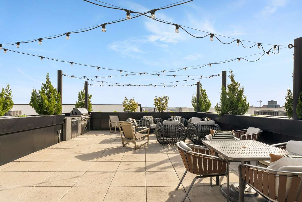 Beautiful rooftop with gas grills, firepit, seating areas and downtown views