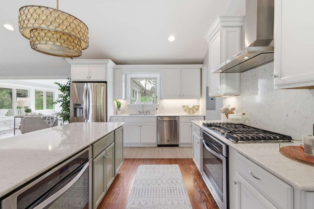 Two ovens offer great spaces for the cook in your family and I am always a fan of a window above the kitchen sink!!!