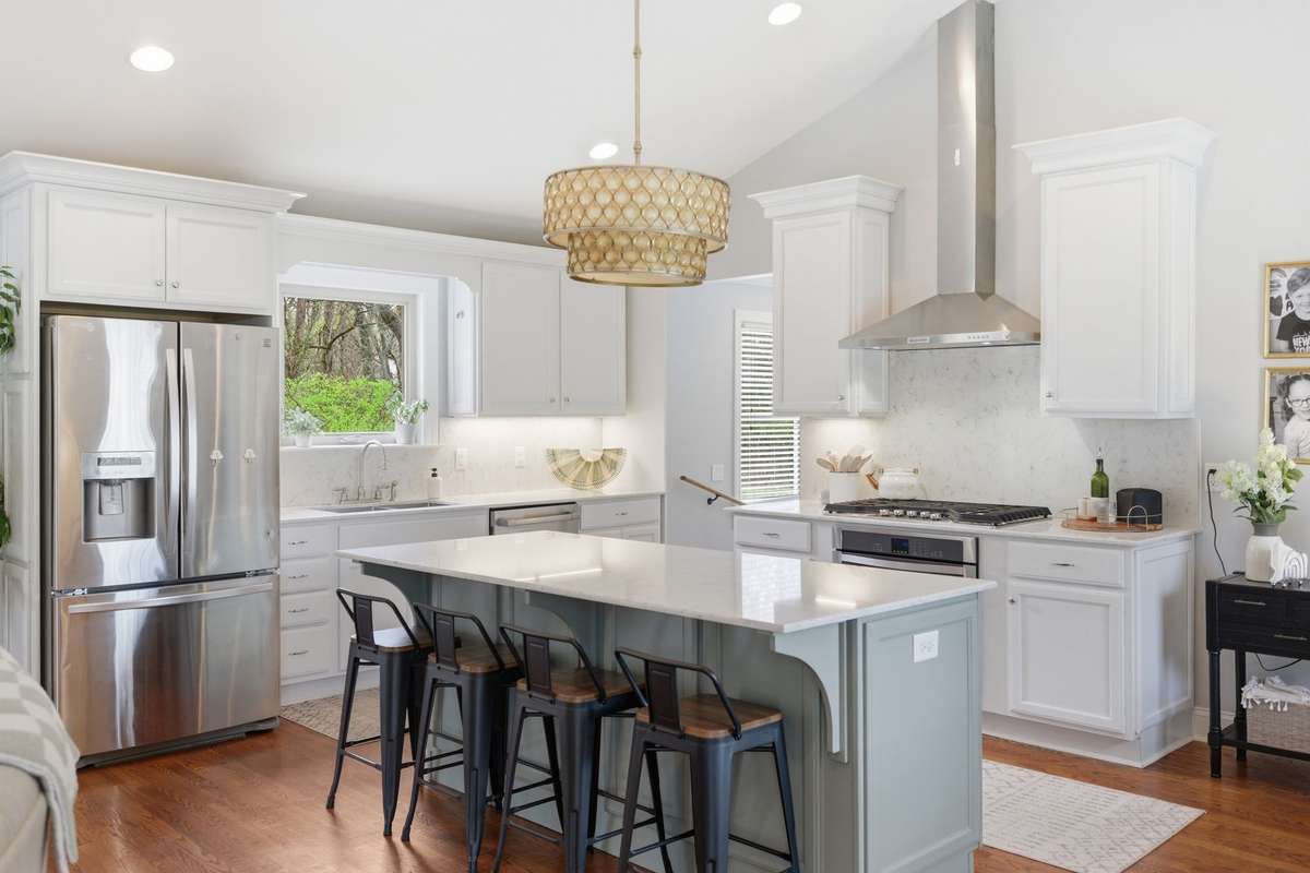 The kitchen offers counter seating at the eat-in island, as well as a gas stove.