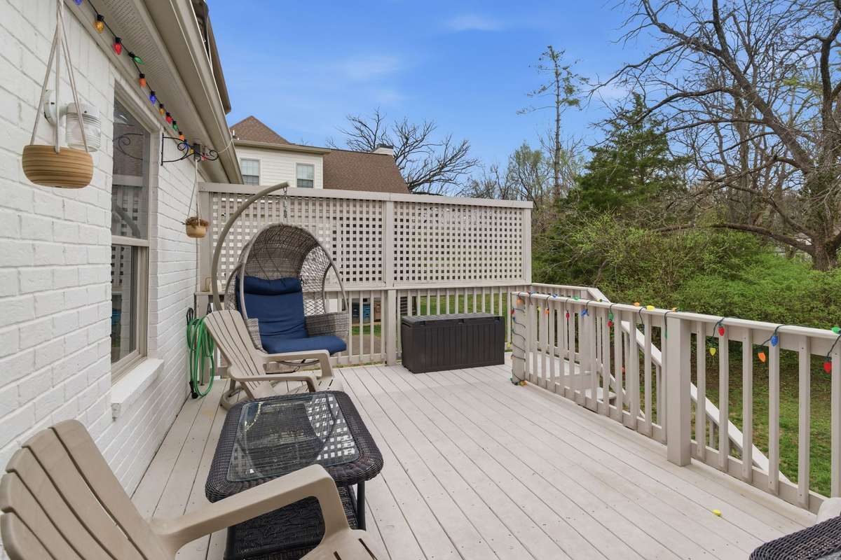 This back deck features a retractable awning and is accessed from the sunroom