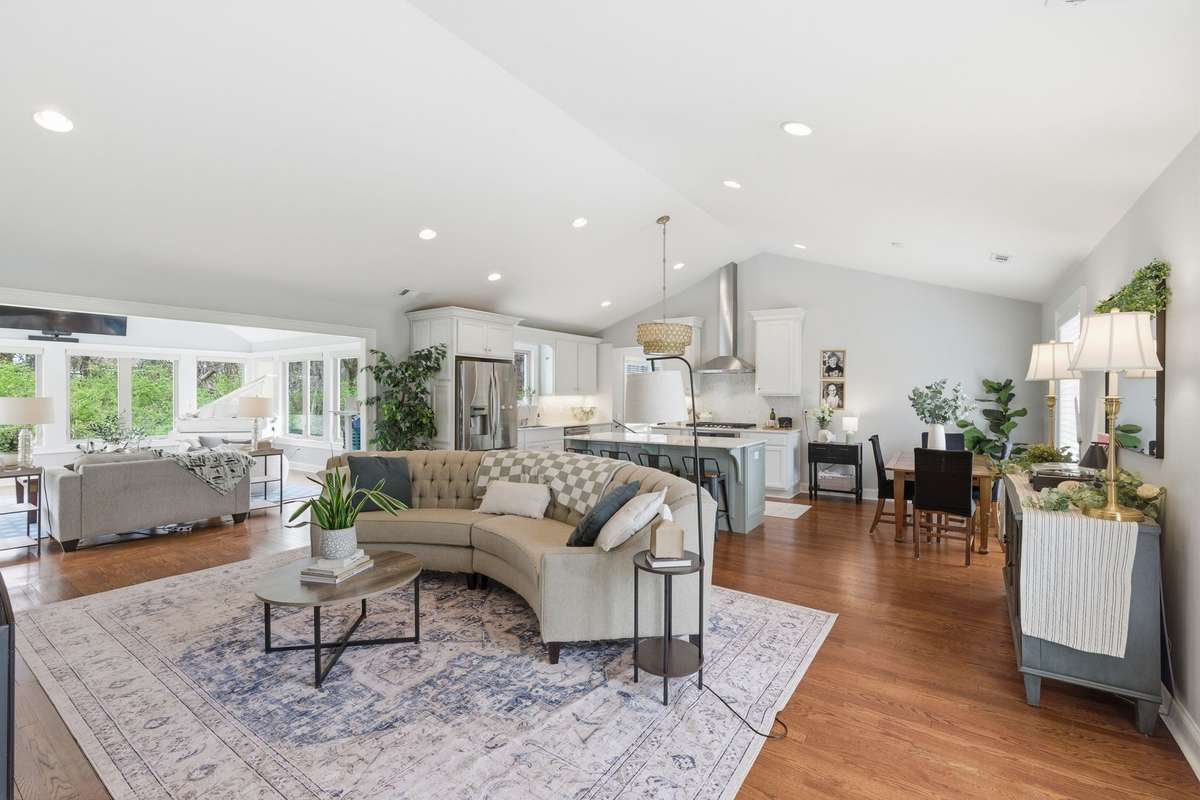 In my opinion, these types of living spaces simply cannot be found in most any home in this price point in this area.  The impressive living room with its vaulted ceiling filled with natural light flows easily into the kitchen beyond.