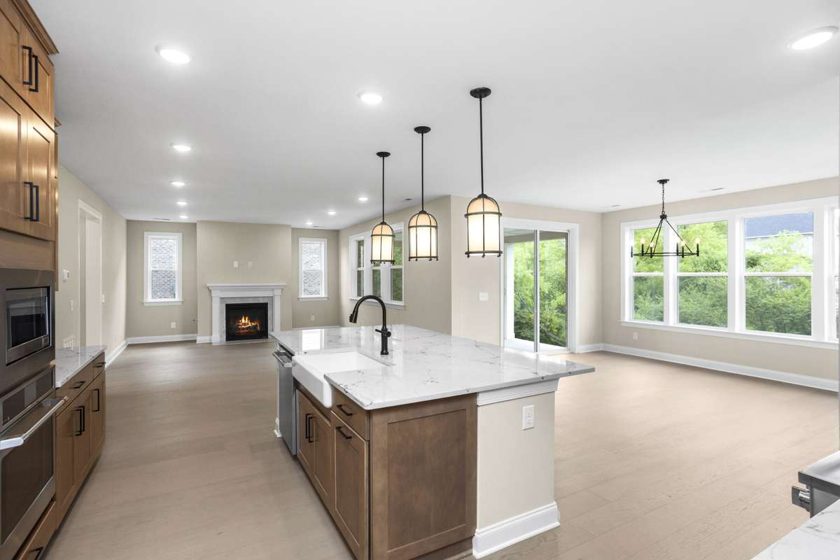 View of the kitchen looking into the dining area and family room
