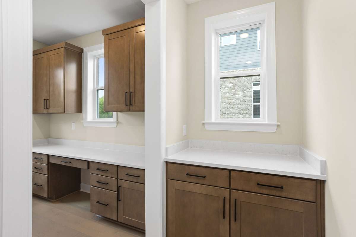 Drop zone from garage entry and a peek into the mini office space and entry to the oversized pantry