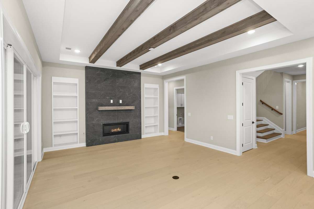 Another view of the family room, front hall way to the stairs and in the back corner the 1st floor laundry