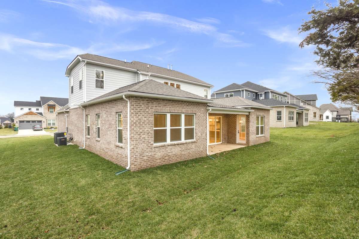 View of back of the home and the yard