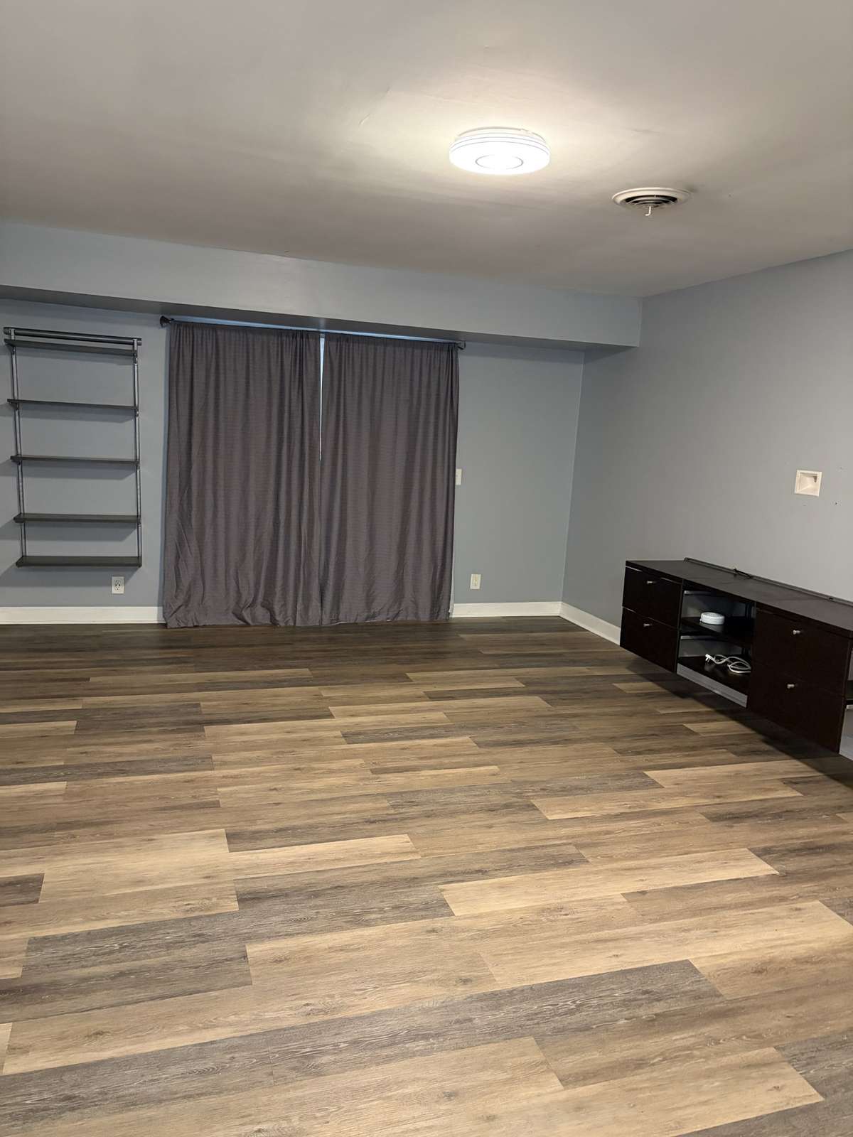 Spacious den with new paint and floors