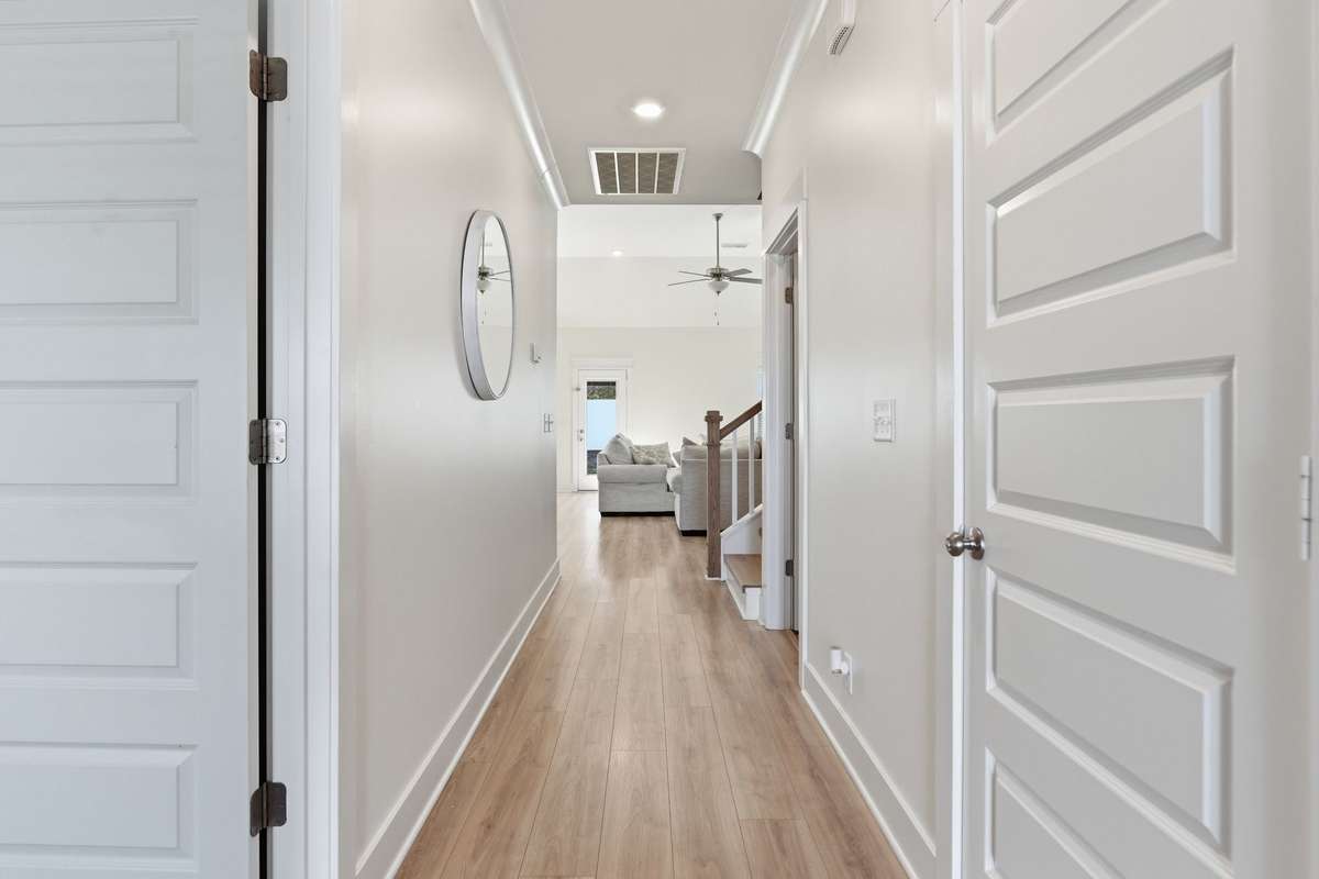 Welcome inside to a bright and inviting hallway that leads you effortlessly into the heart of the home. This thoughtfully designed layout features two bedrooms on the main level in a split (zoned) arrangement, offering added privacy and functionality