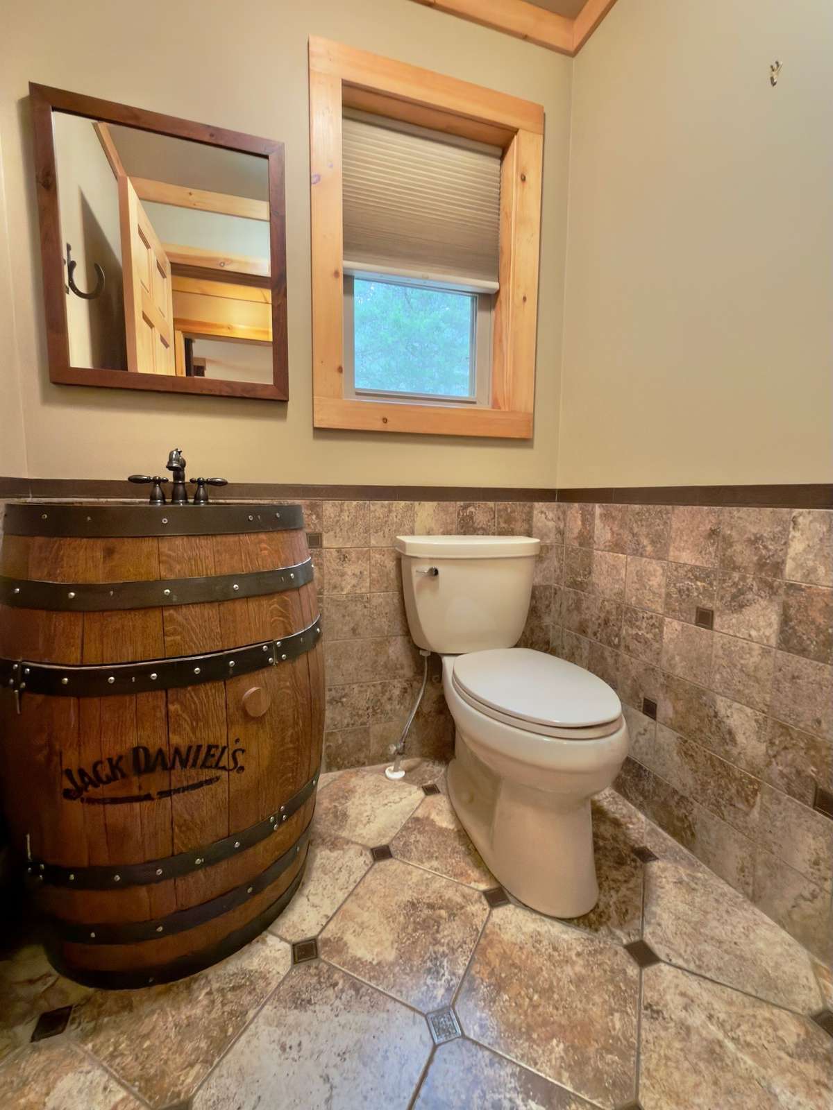 Custom half bath with Jack Daniel's barrel sink.