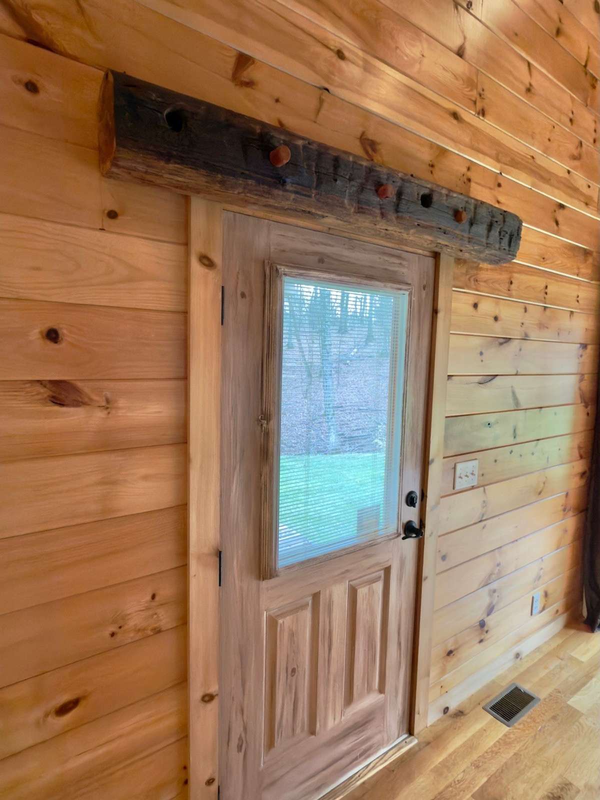 Hand hewn log transom over front door.
