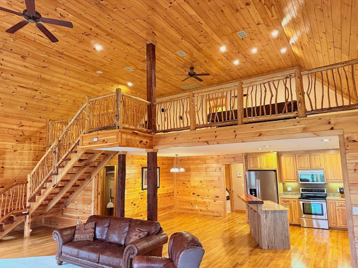 Custom cedar stair case, bannister and spindles leading to second level of home.