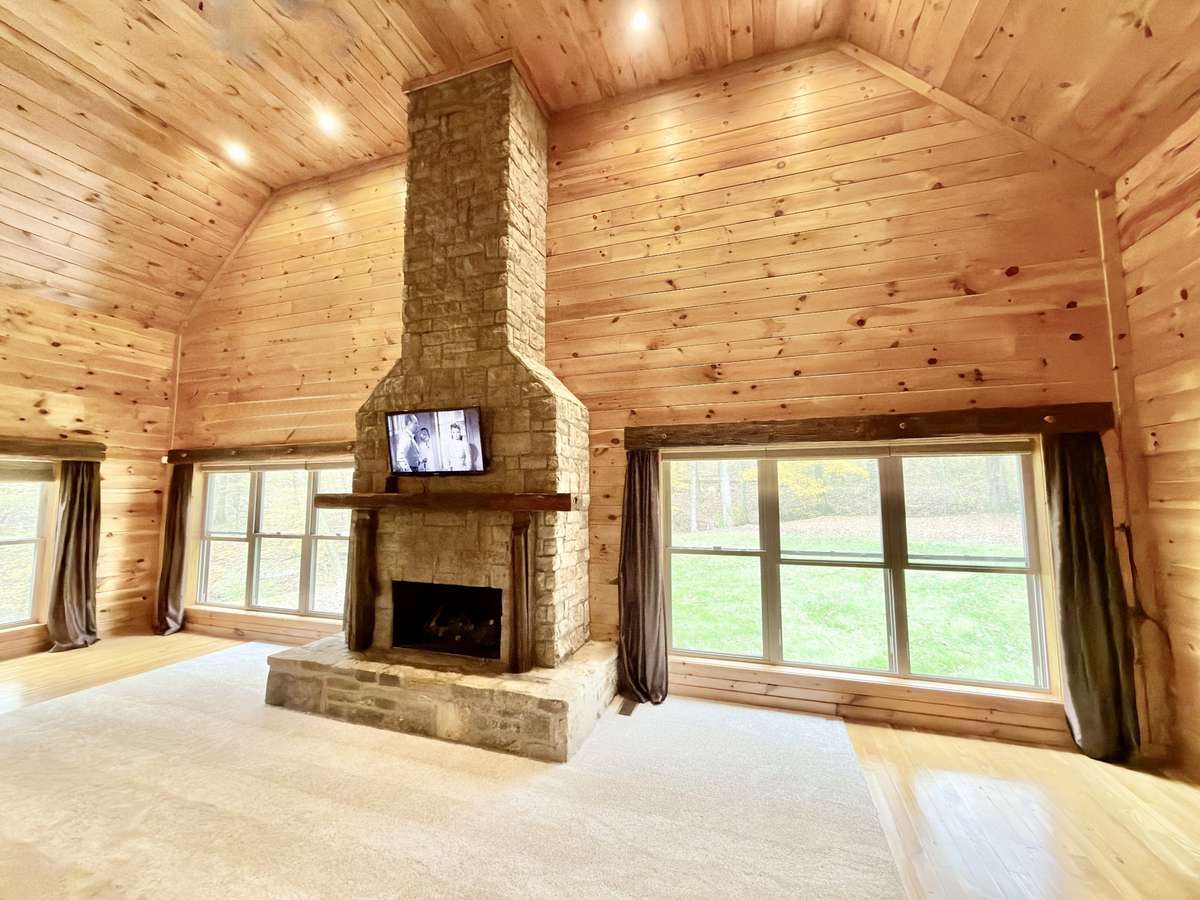 Mid-west lodge style great room with 22 ft stone fireplace.