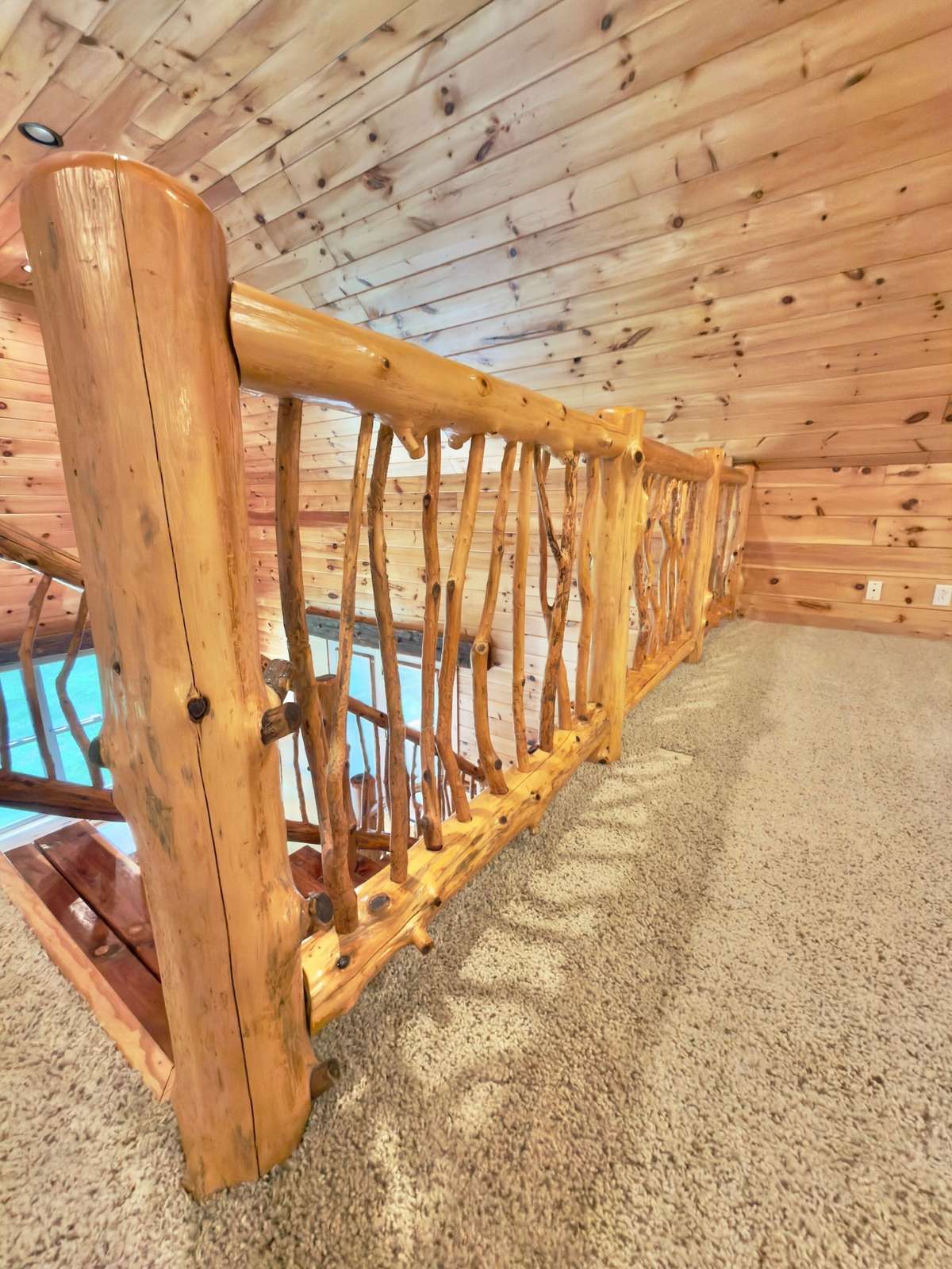Custom crafted bannister and spindles from cedar trees on the property.
