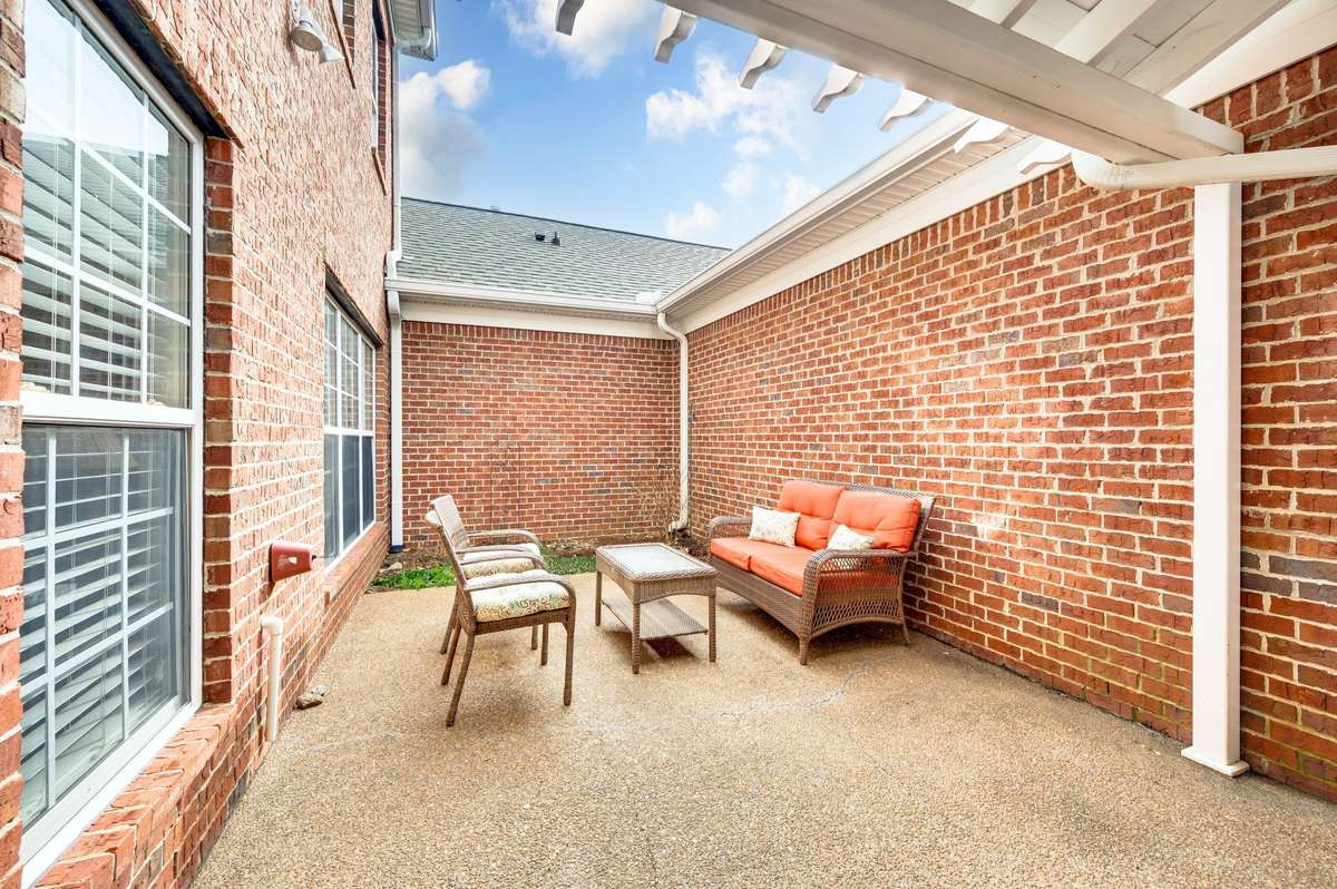 Private back patio is ideal for grilling or entertaining family and friends.  Covered walkway to the 2 car garage