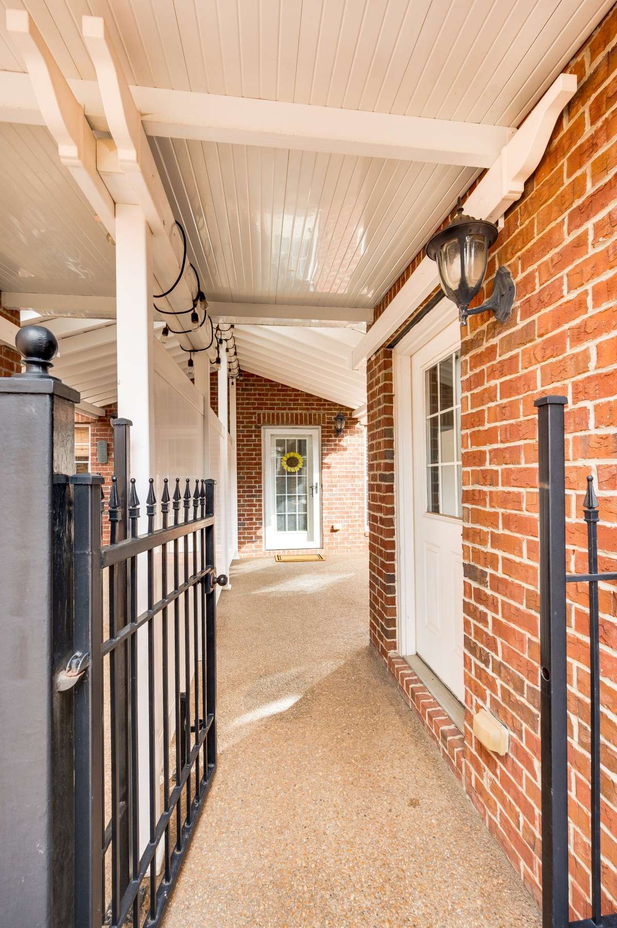 Gated and covered access from garage pedestrian door to home