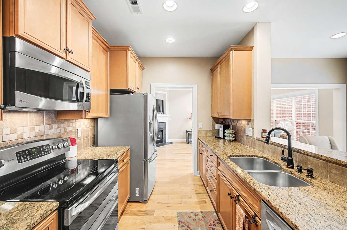 All stainless steel appliances include a smooth top range with double oven, microwave, dishwasher and refrigerator.  Food prep is a breeze on the granite countertops when lit up with under cabinet lighting.