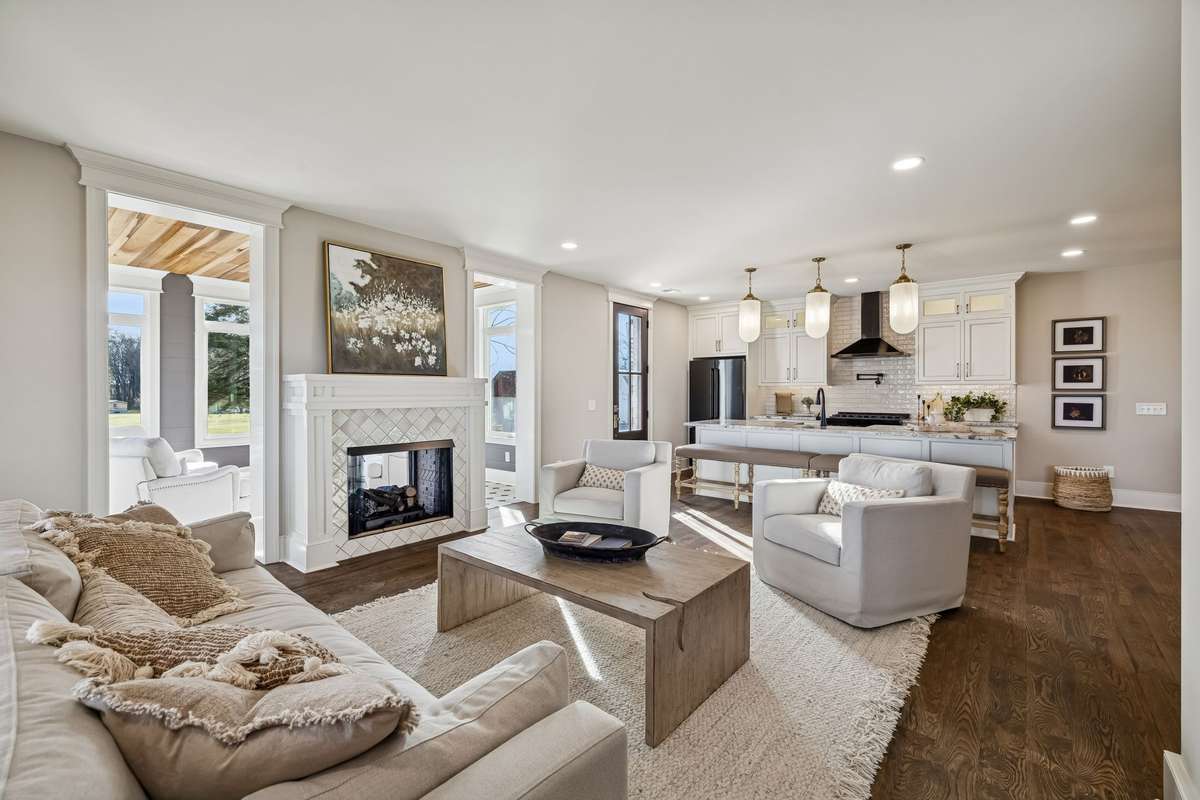 Larger living room with gas fireplace shared with the sunroom.