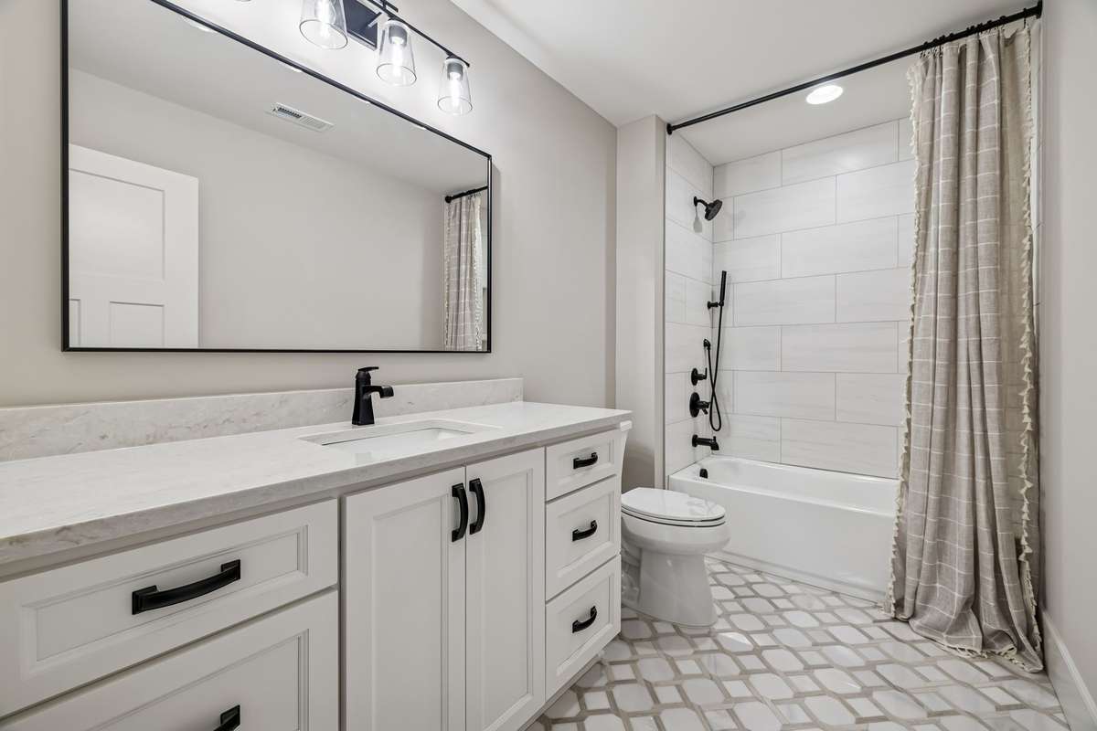 Upstairs bathroom with tile floors and tile tub surround