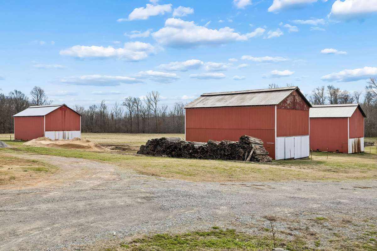 Three tobacco barns, Two barn with newer roofs 2024.