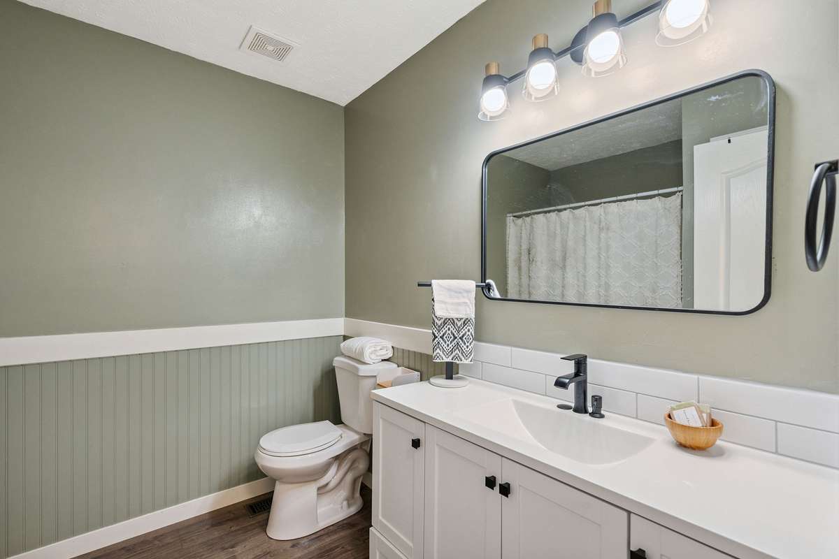 One of the 2 downstairs bathrooms in this 4 bedroom, 3 and a half bathroom in Murfreesboro Tennessee with over half an acre of land and no HOA, a two car garage and updated kitchen.