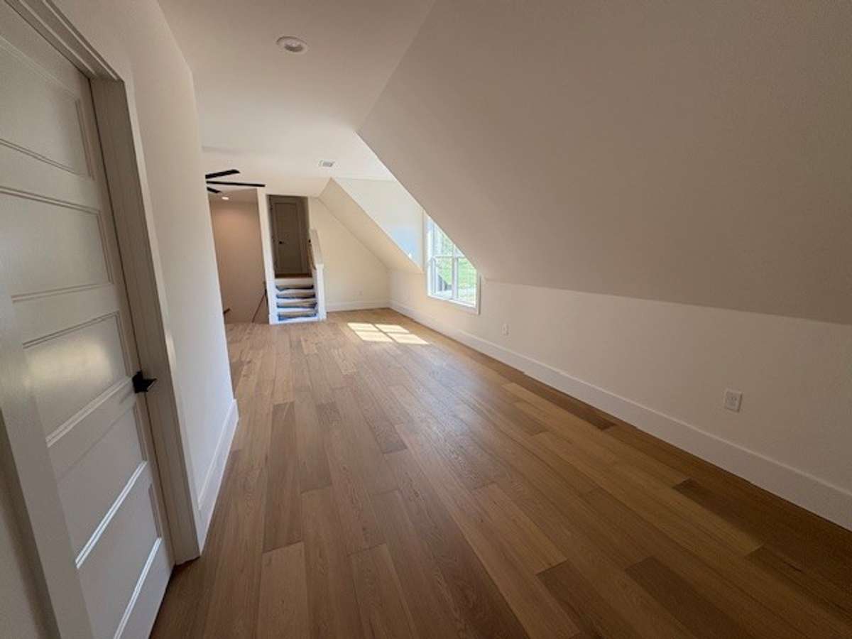 Antoher angle of upstairs taken from storage closet: flex room on left and full bath is at top of those few stairs