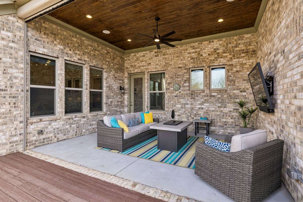 Fabulous patio with stained bead board ceiling and motorized retractable screen. The screen allows for this space to be enjoyed rain or shine.