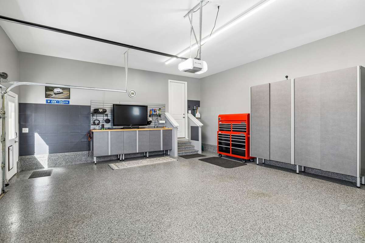 The garage is as well-maintained as the interior with an epoxy floor and custom storage cabinets which will stay. There is an electrical outlet located inside the cabinet on the right.