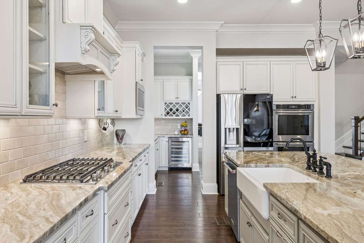 Incredibly beautiful and functional Kitchen has a gas cooktop and farm sink. Just beyond is the spacious Butler's Pantry.