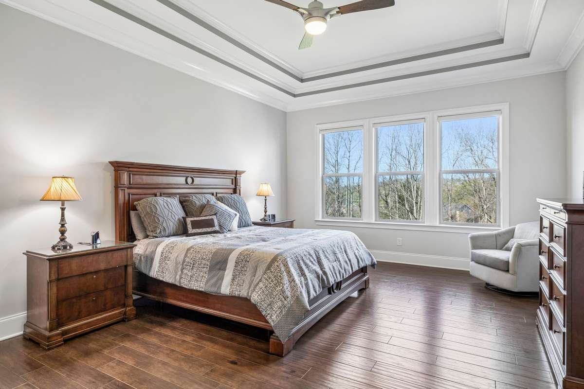The Roomy Primary Bedroom overlooks the private back yard with tinted windows and Duolite Sihlouette Blinds.
