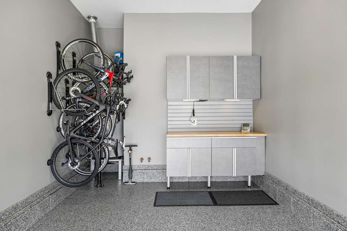 The bike racks and the cabinetry will remain in the single bay garage.