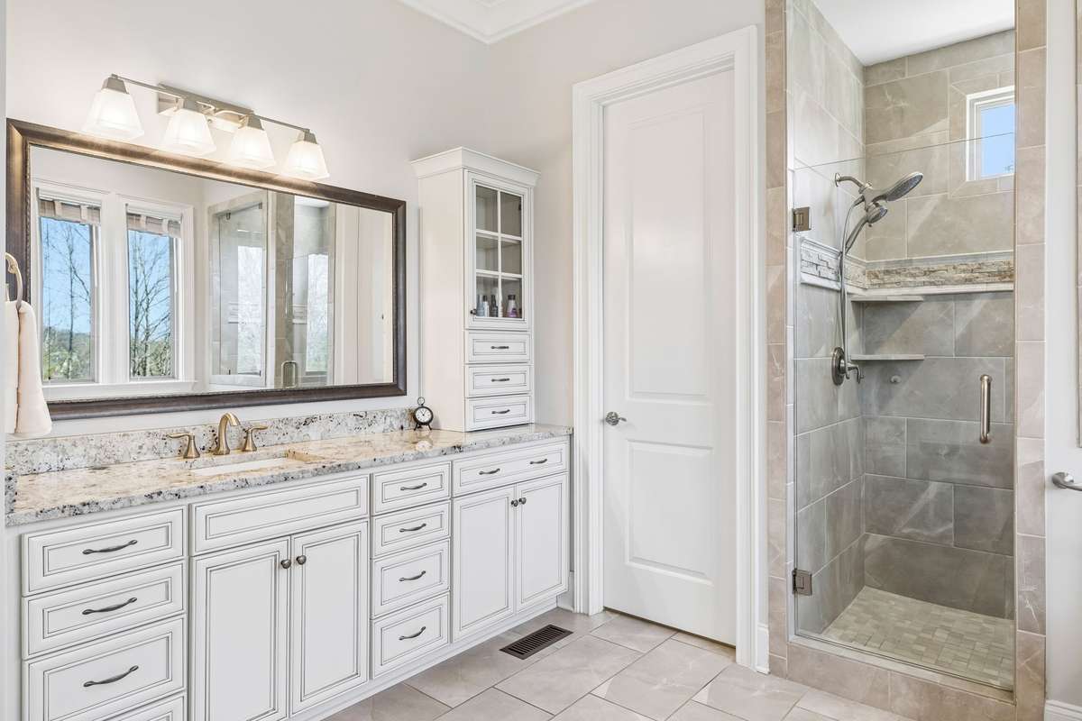 Two vanities with quartz counters and ample storage