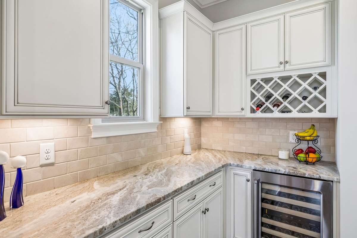 Large Butler's Pantry with an abundance of cabinet and prep space. The beverage cooler is a fabulous feature, too. The food pantry is just a few steps away.