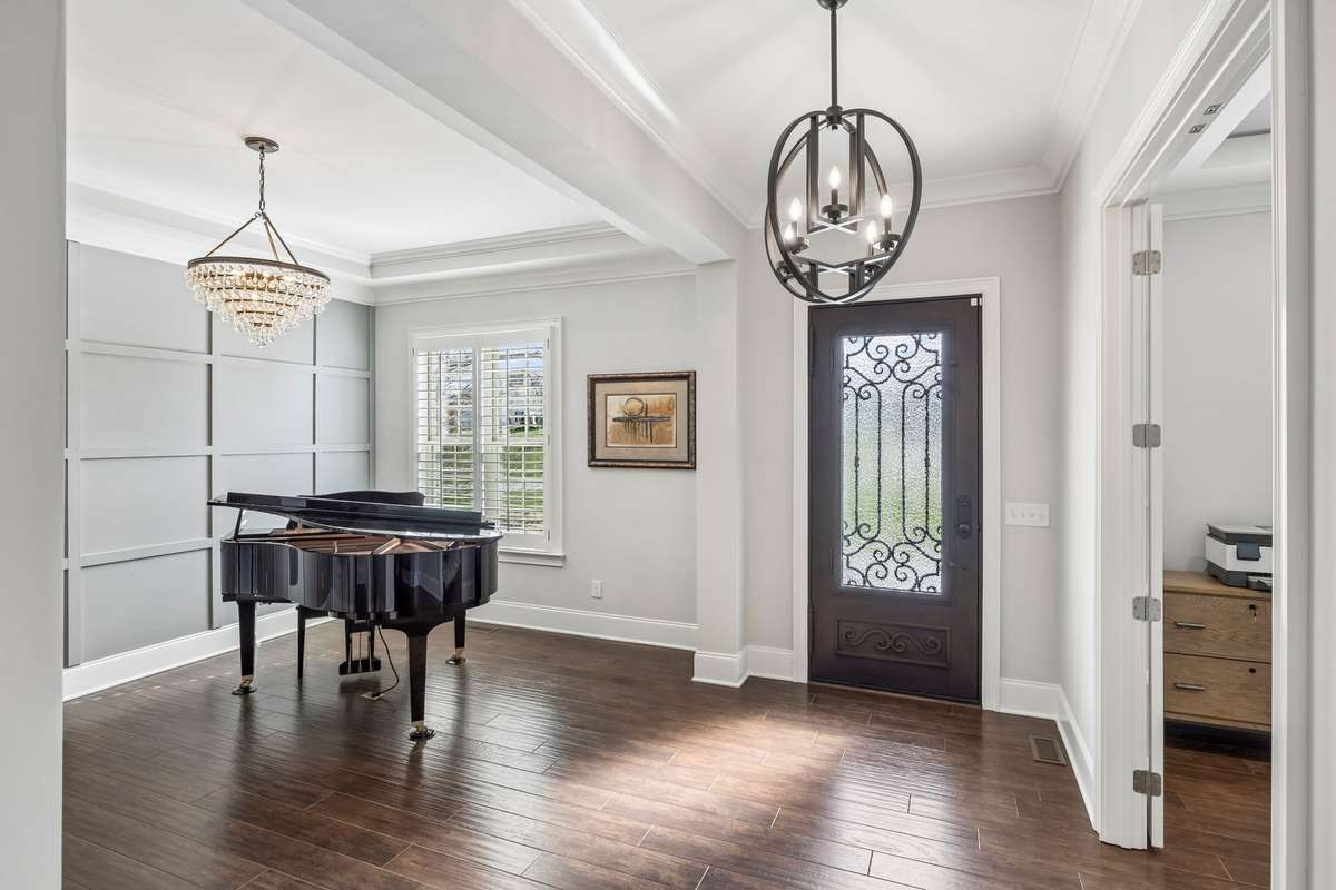 The Dining Room is currently used as a music room and has a gorgeous chandelier and a board and batten accent wall.