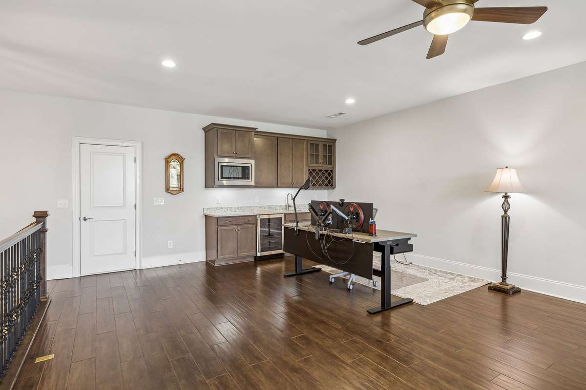 At the top of the stairs is the multi-purpose Bonus Room complete with a wet bar that includes a beverage refrigerator, microwave and sink. The door to the left gives access to a wonderful walk-in storage space.