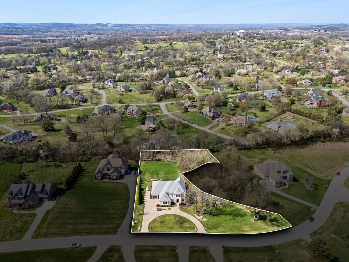The well-maintained yard provides lots of privacy. In addition to the acreage, owners can enjoy the treed area to the right of the house that is owned by the HOA.