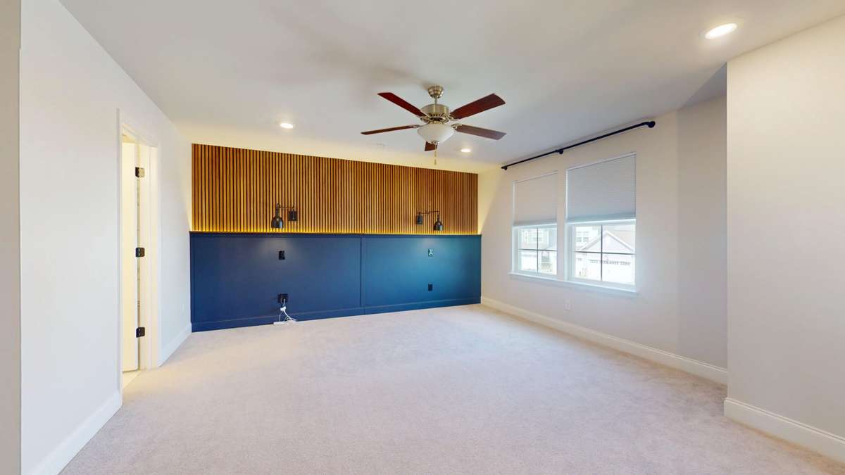 The primary bedroom suite has been upgraded with custom lighting and accent walls.
