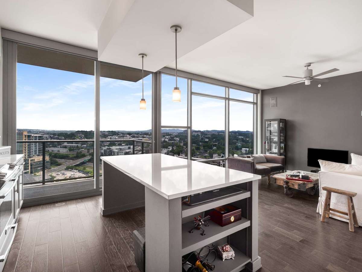 Abundant natural light flows through the expansive floor to ceiling glass in the living space with panoramic southeasterly views of the Gulch neighborhood and beyond
