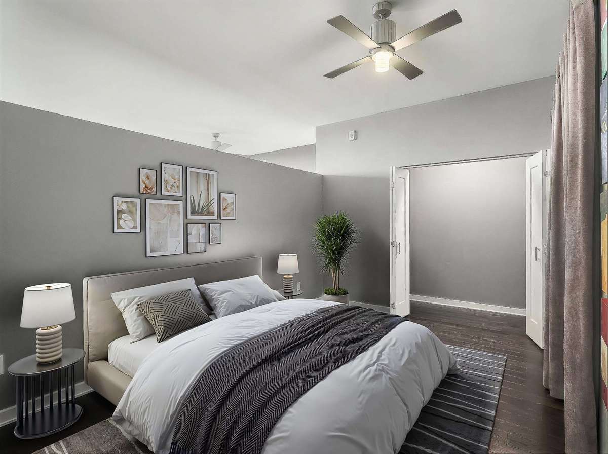 Virtual Staging of Actual Unit showing King Bed and side tables.  Closet does have an elf system installed.