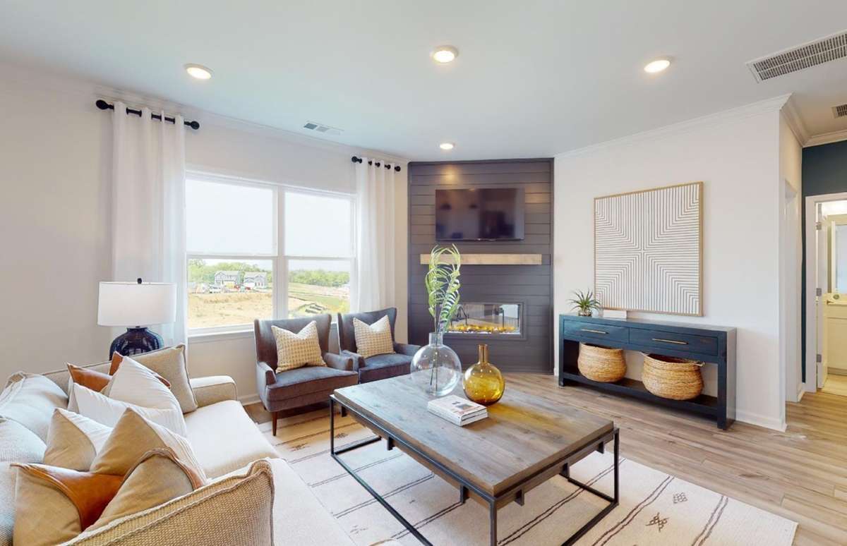 Example / Model photo. 

Great Room features Luxury Vinyl Plank flooring Included. Note: Hampton home number 264 does not include the optional corner fireplace. The great room is squared off, instead. See layout in listing documents.