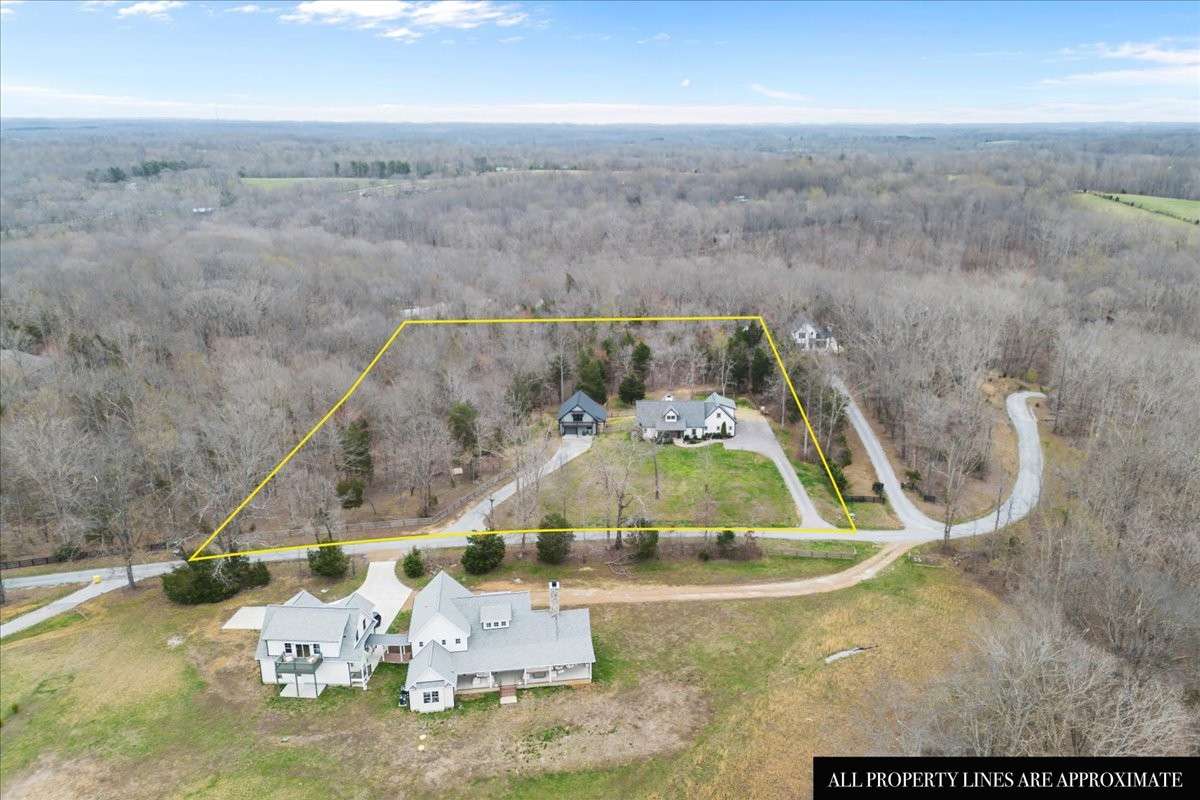 The property goes across the street to the tree line.