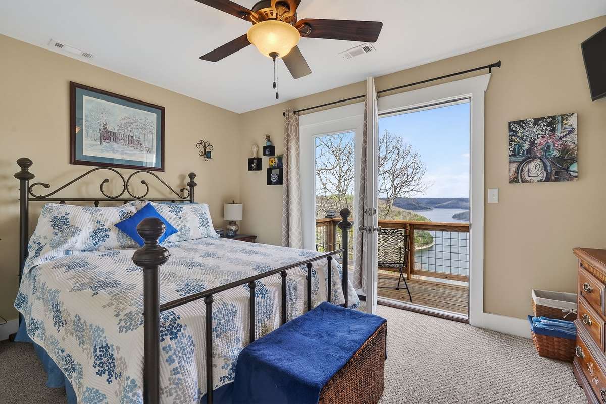 3 bedroom leading out to deck with lake views