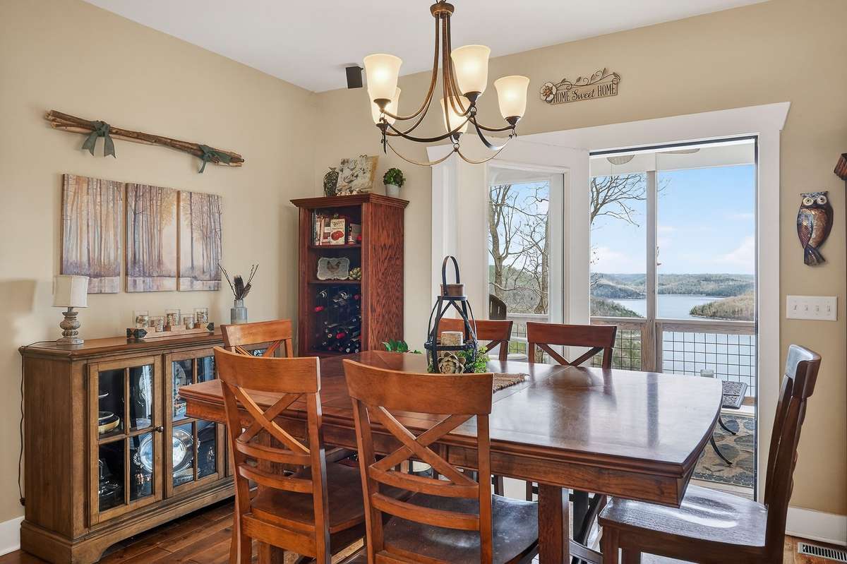 Lake views from dining room leading out to covered deck