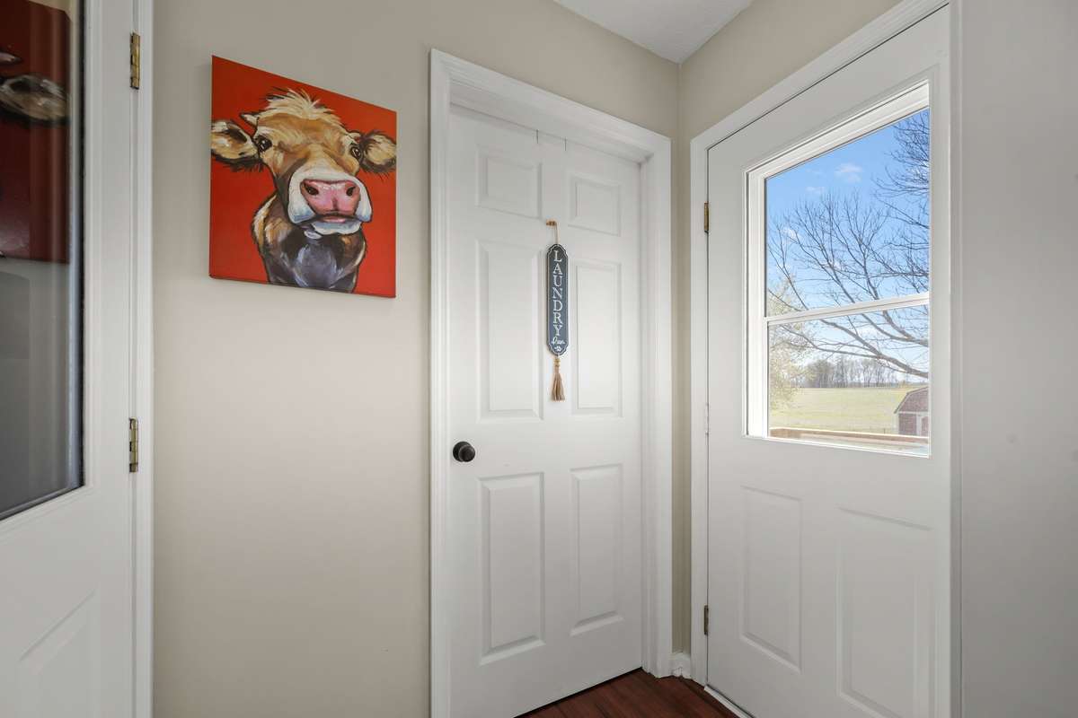 Hall area for entering house from garage, going into the utility room  and going onto the deck in the backyard