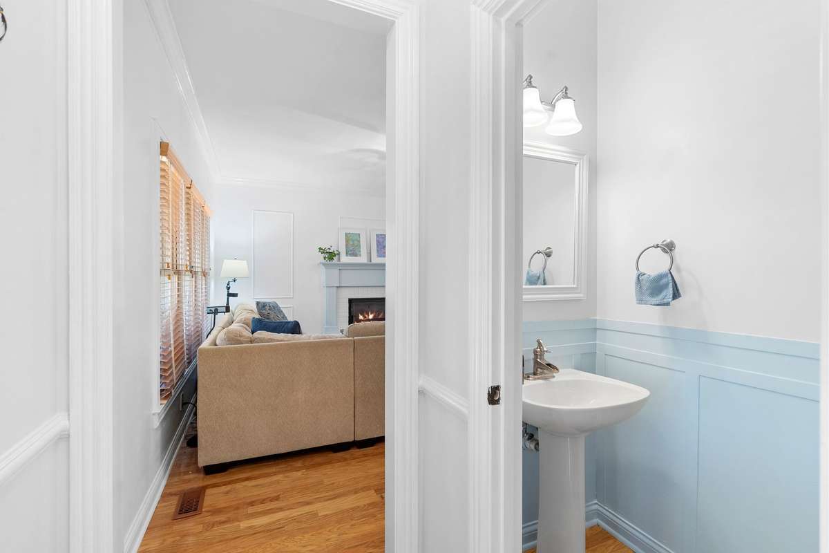 Just past the living room is the guest half bath, which also has been freshly painted.