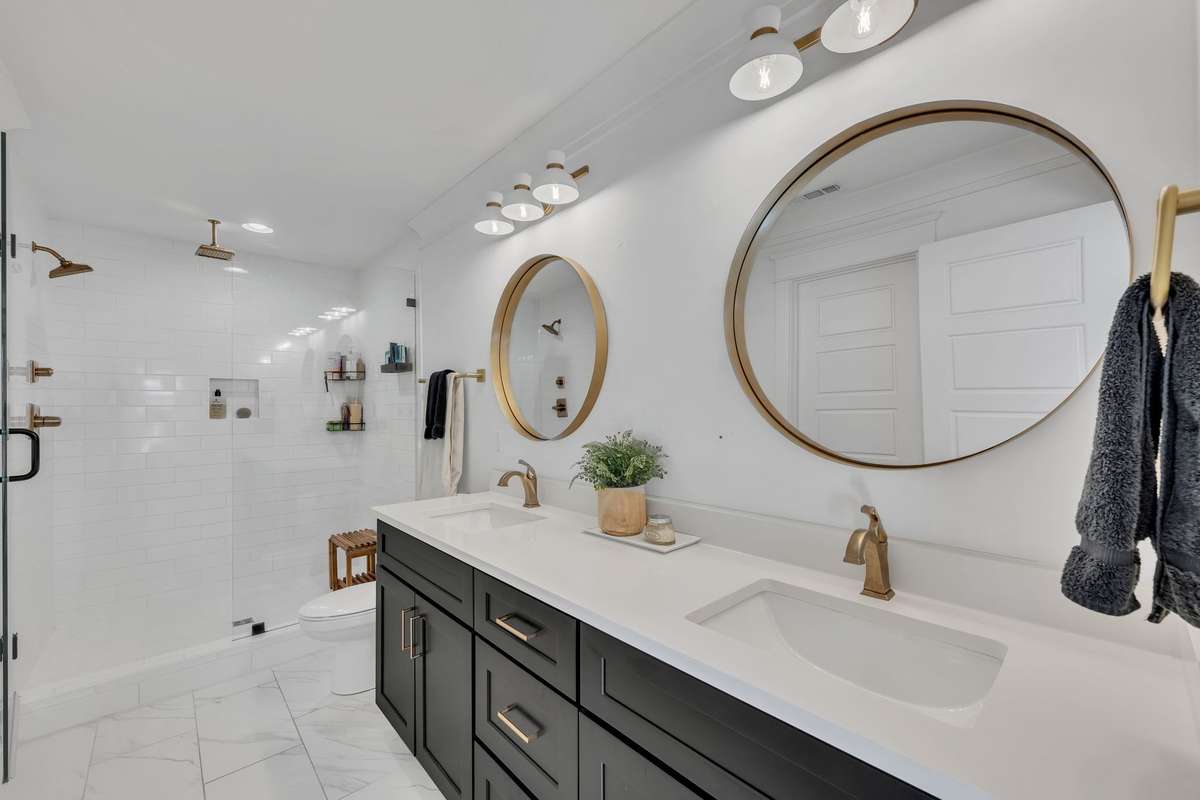 Primary Bathroom has double vanities and a large walk in shower