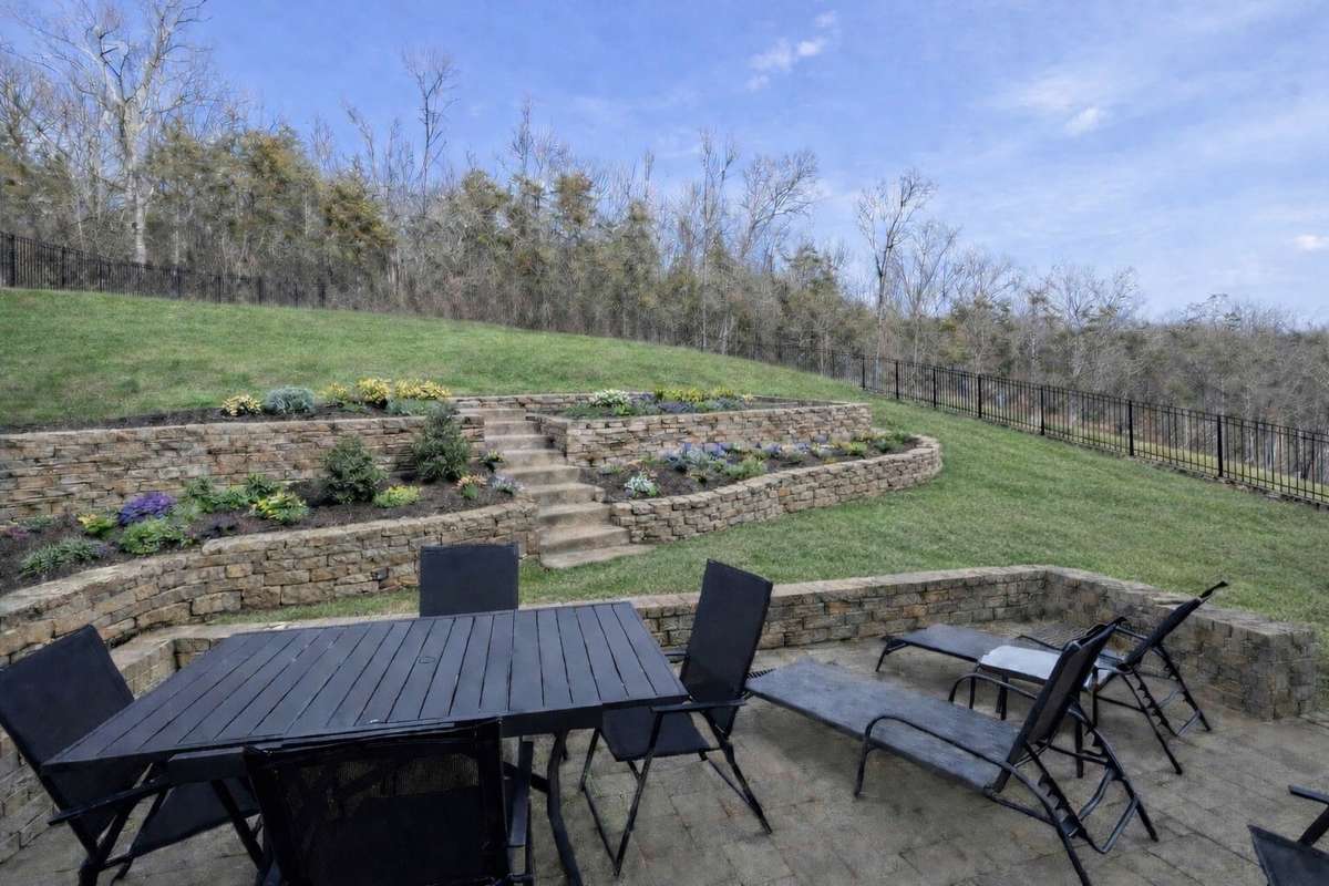 NOTE:  CONCEPTUAL AI-GENERATED PHOTO SHOWING HOW THE BACKYARD COULD BE DESIGNED.  IT IS NOT INCLUDED IN PRICE (It was a concept the sellers were considering before they learned they had to relocate.)